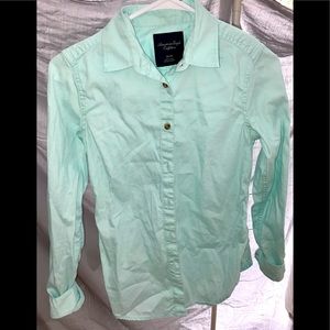 Blue long sleeve button down tee.